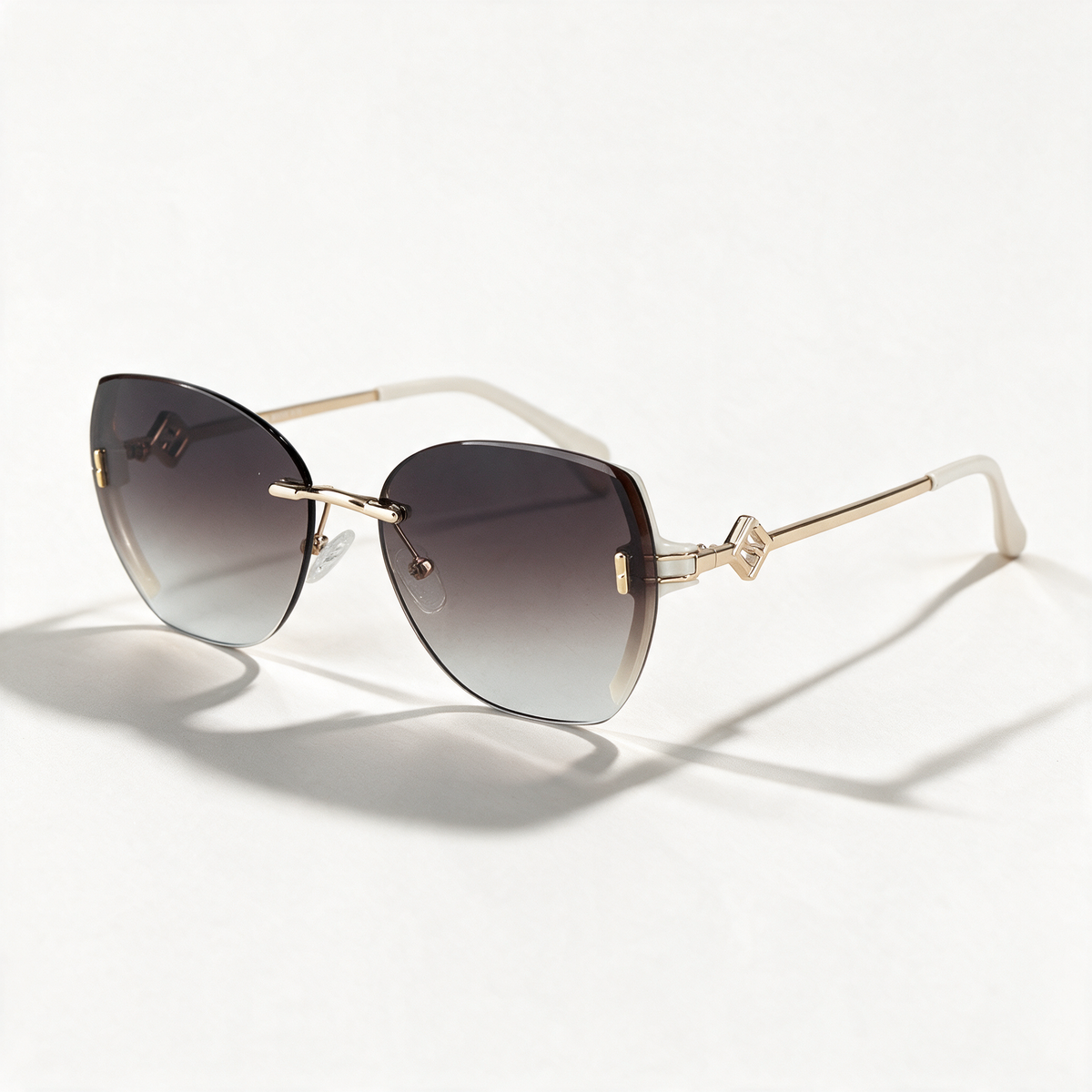 The Blank Tag Bloom rimless butterfly sunglasses for women, coffee with deep-to-clear gradient lens – front view — view 1