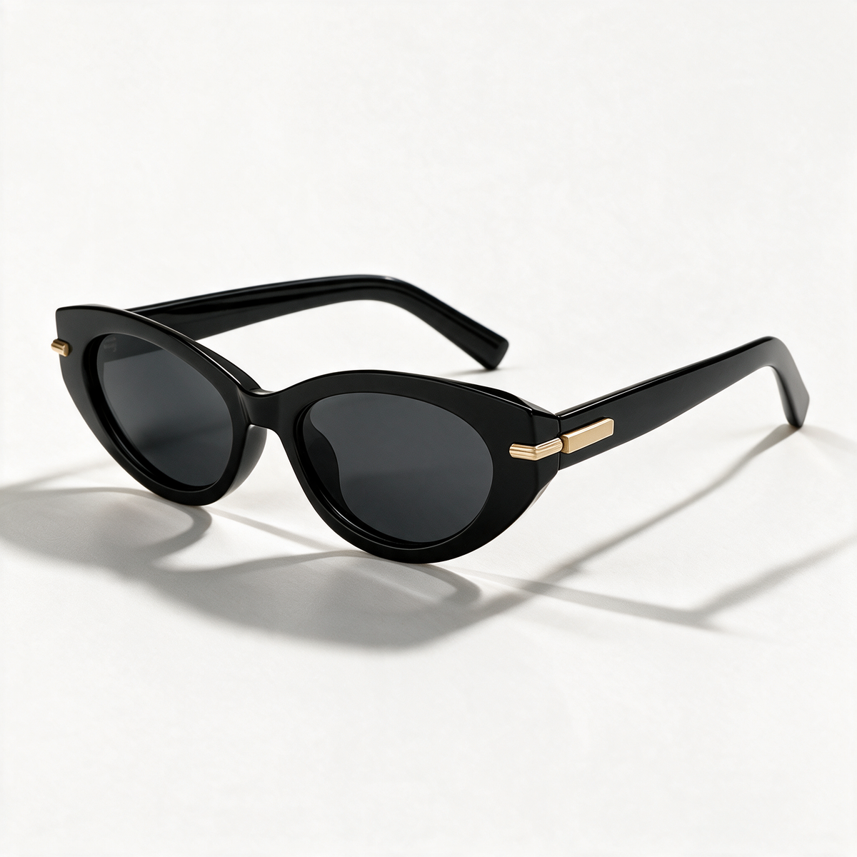The Blank Tag Charmer black polarised cat-eye sunglasses for women with slim gold temple bar – front view — view 1
