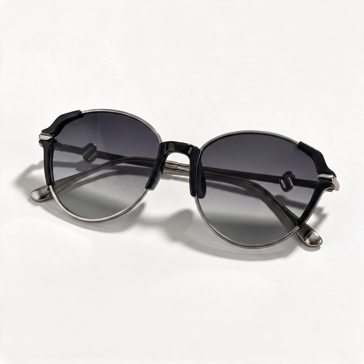 The Blank Tag Refined slim oval polarised sunglasses for women, black with gunmetal rim and grey gradient lens – angled view — view 3