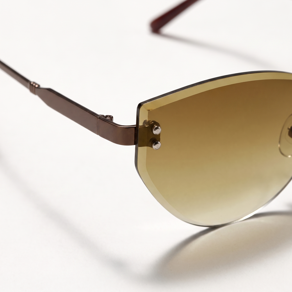 The Blank Tag Ingenue rimless cat-eye sunglasses for women, coffee with brown gradient lens – angled view — view 3