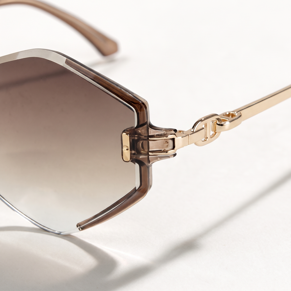The Blank Tag Prism rimless geometric octagon sunglasses for women, gold with faceted brown gradient lens – side view — view 2