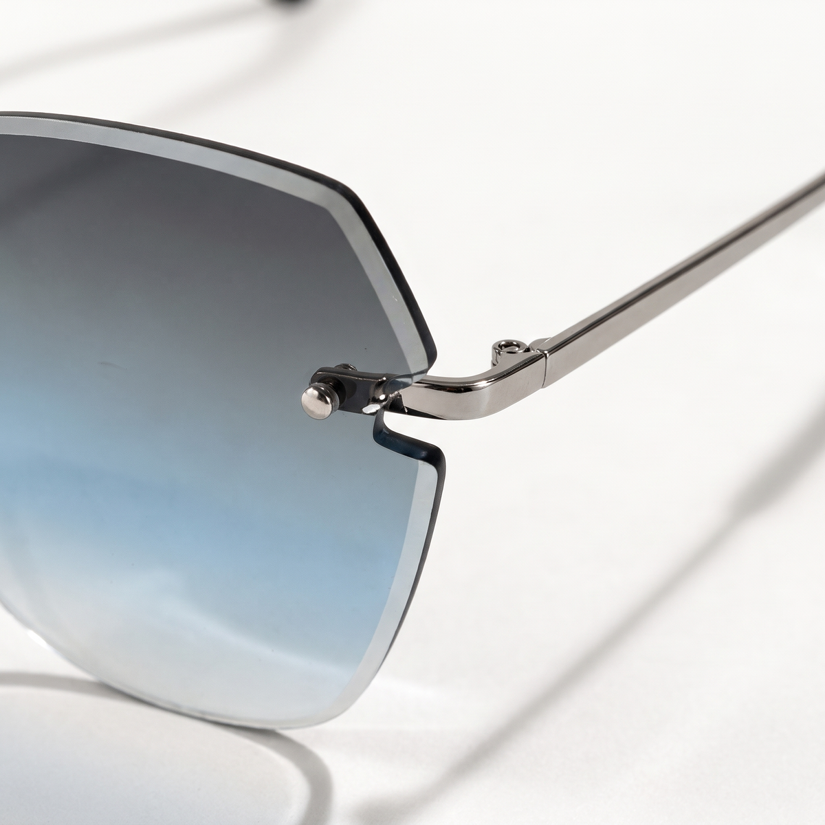 The Blank Tag Lagoon rimless square sunglasses for women, light gun metal with blue-grey gradient lens – side view — view 2