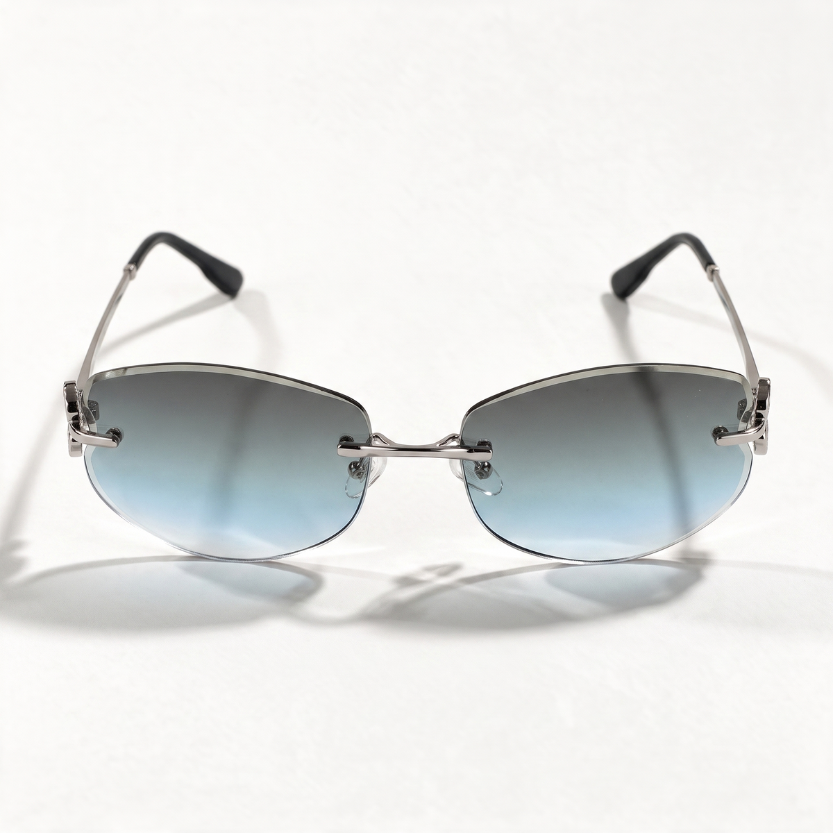 The Blank Tag Mermaid rimless oval sunglasses for women, light gun metal with grey-blue gradient lens – side view — view 2