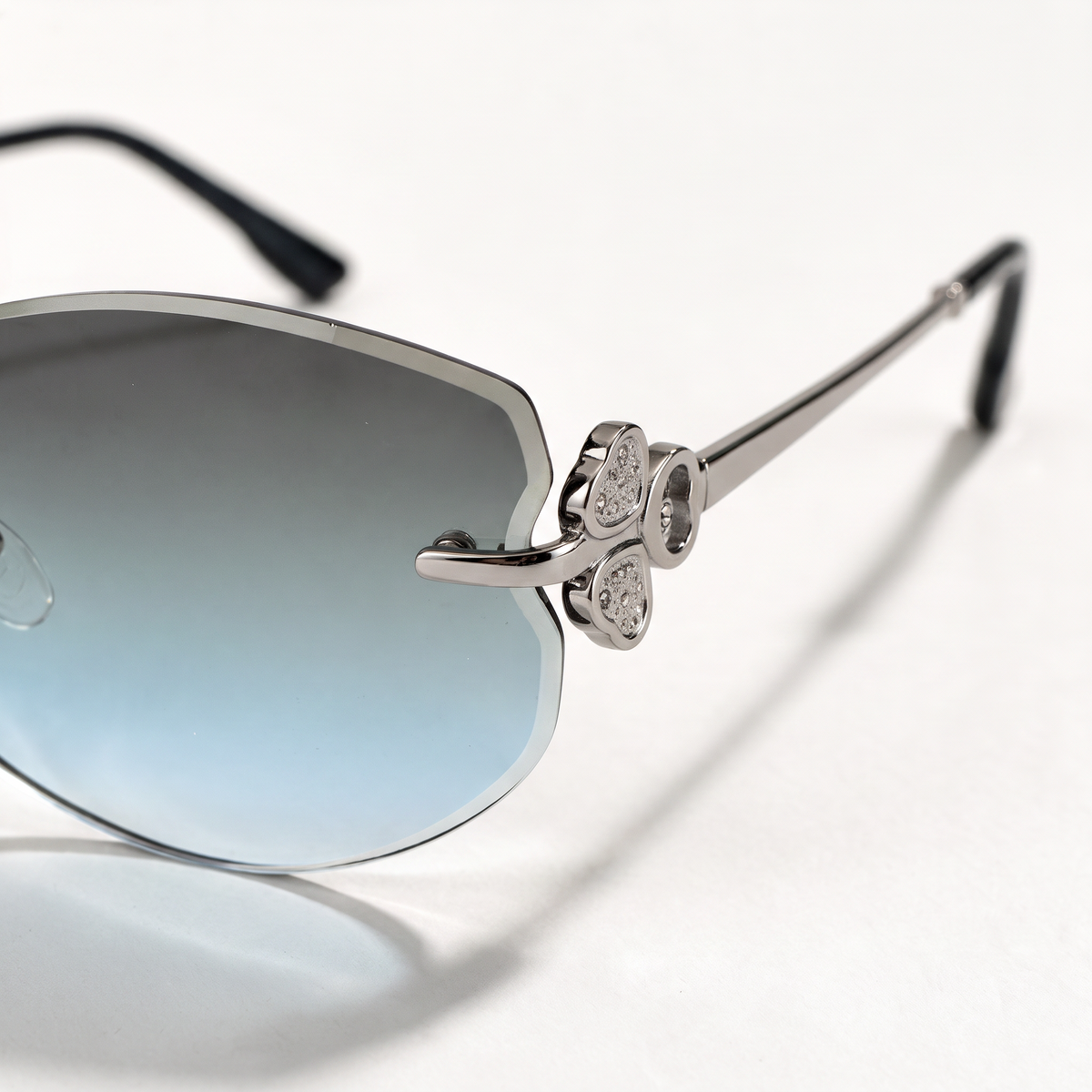 The Blank Tag Mermaid rimless oval sunglasses for women, light gun metal with grey-blue gradient lens – angled view — view 3