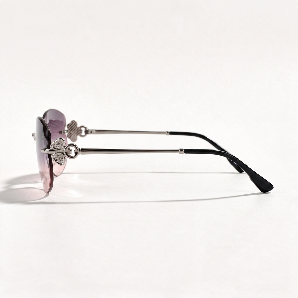 The Blank Tag Mermaid rimless oval sunglasses for women, gun metal with purple-pink gradient lens – side view — view 2