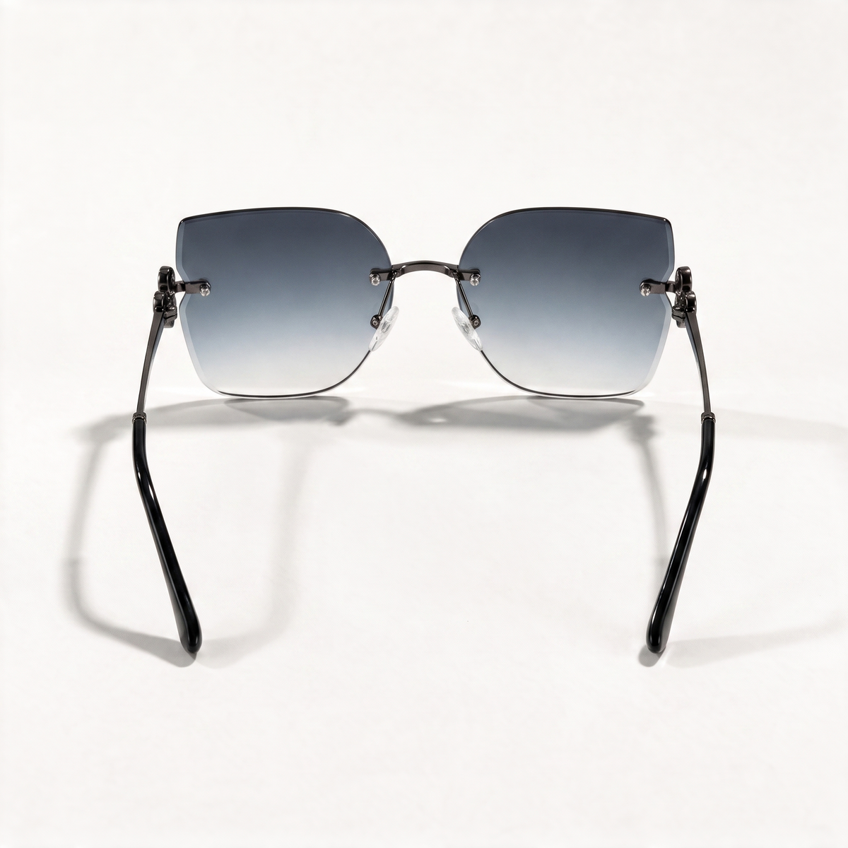 The Blank Tag Empress rimless square sunglasses for women, gun metal with smoky grey gradient lens – angled view — view 3