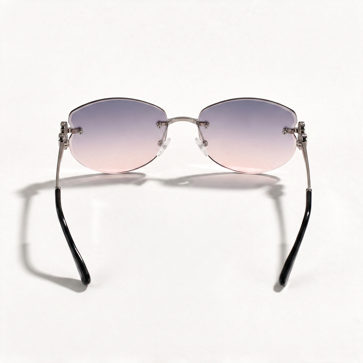 The Blank Tag Mermaid rimless oval sunglasses for women, gun metal with purple-pink gradient lens – angled view — view 3