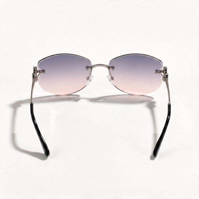 The Blank Tag Mermaid rimless oval sunglasses for women, gun metal with purple-pink gradient lens – angled view — view 3