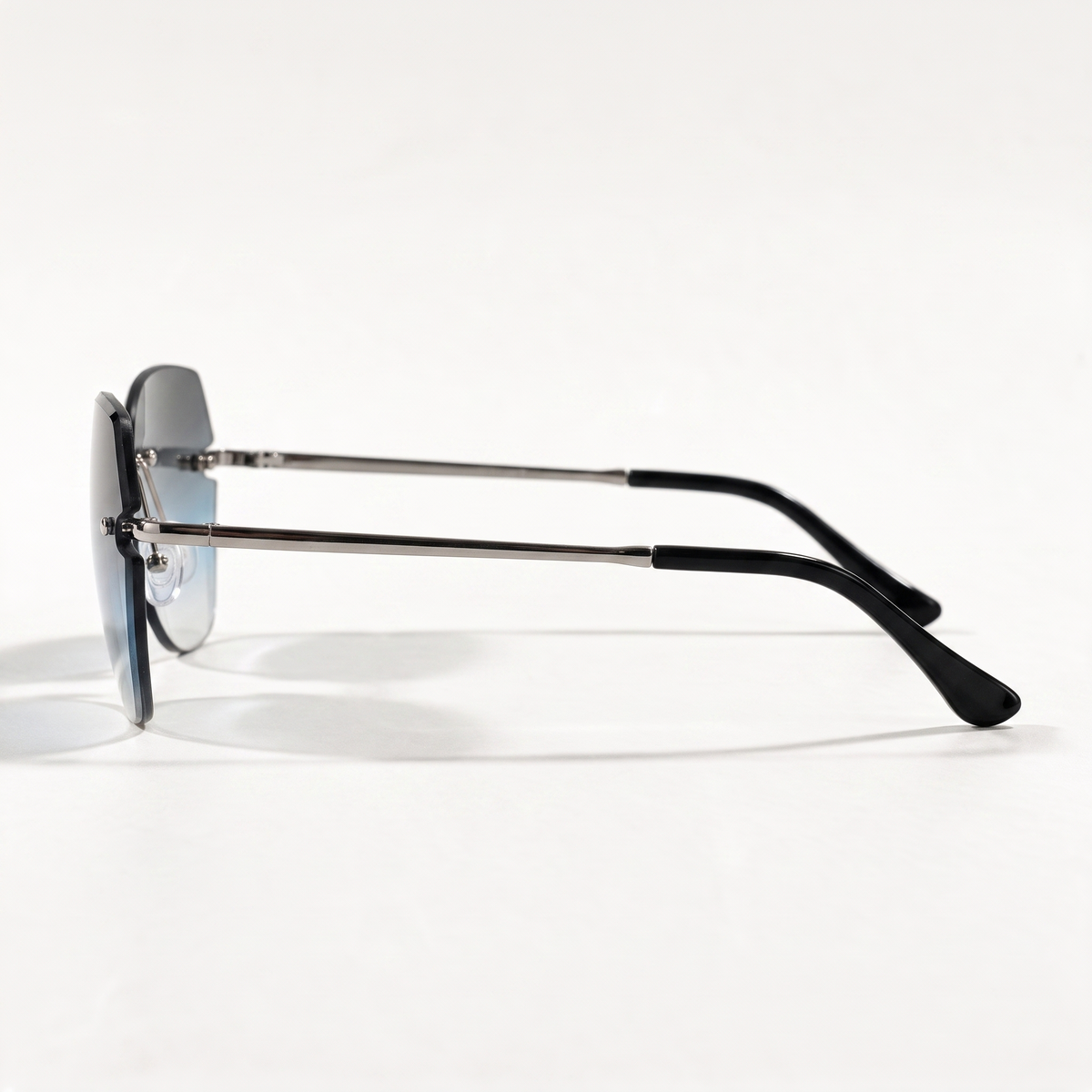 The Blank Tag Lagoon rimless square sunglasses for women, light gun metal with blue-grey gradient lens – angled view — view 3