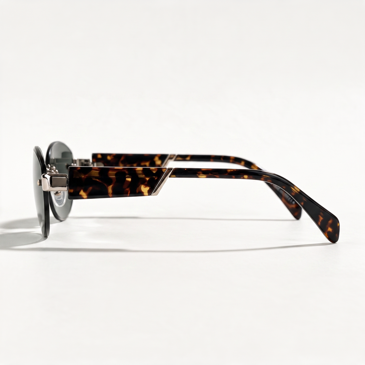 The Blank Tag Luna small rimless oval sunglasses for women, tortoise temples with deep green lens – side view — view 2