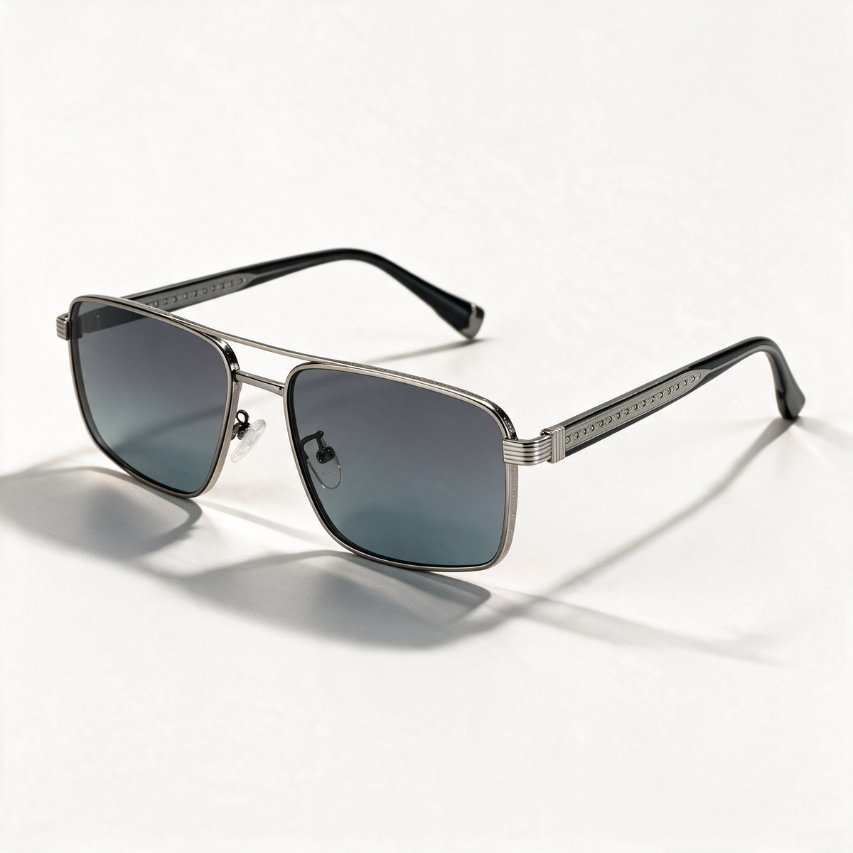 The Broker light gun metal navigator sunglasses with engraved temples and grey blue lenses — view 1