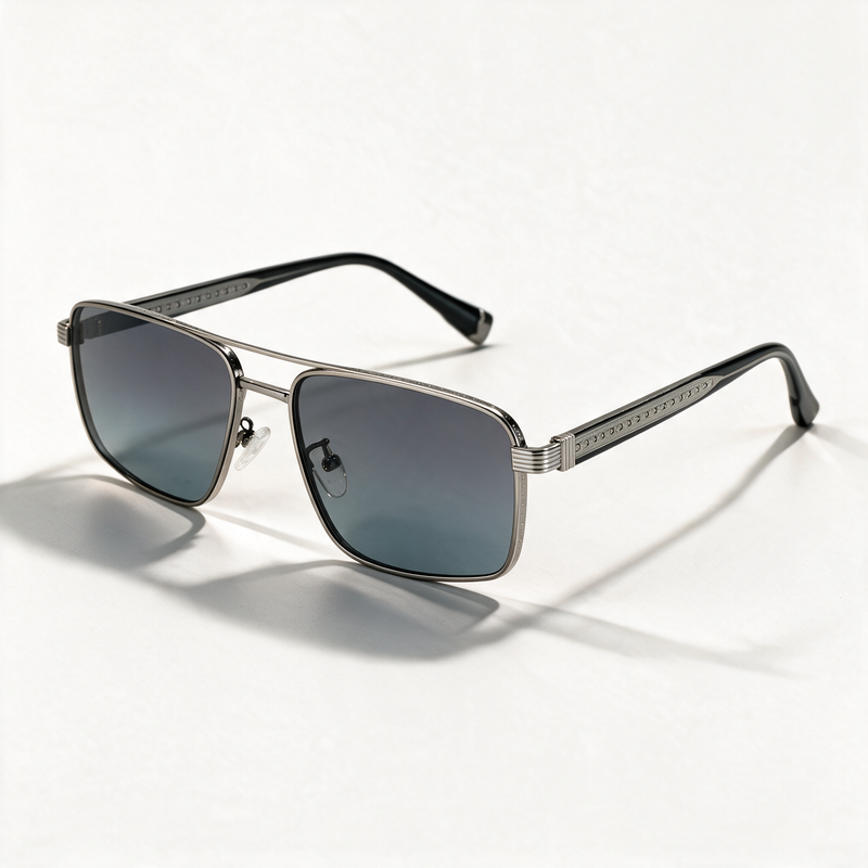 The Broker light gun metal navigator sunglasses with engraved temples and grey blue lenses — view 1