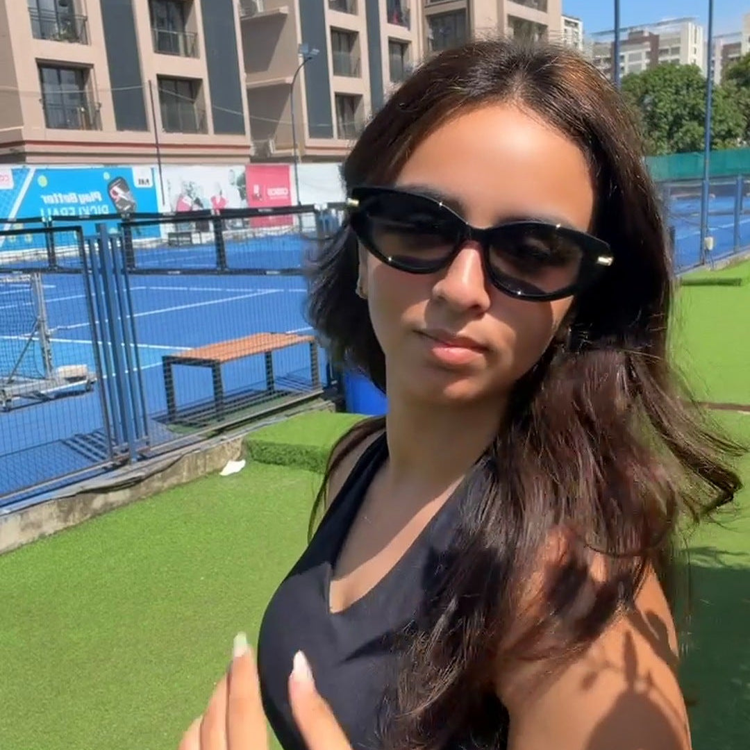 The Blank Tag Charmer black polarised cat-eye sunglasses — worn outdoors — view 5